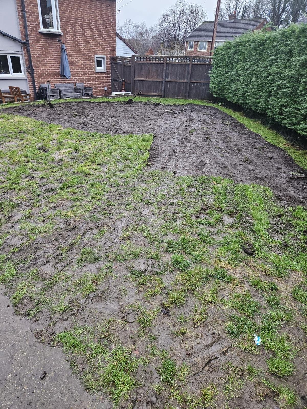 Muddy pet garden before durable turf in Walker